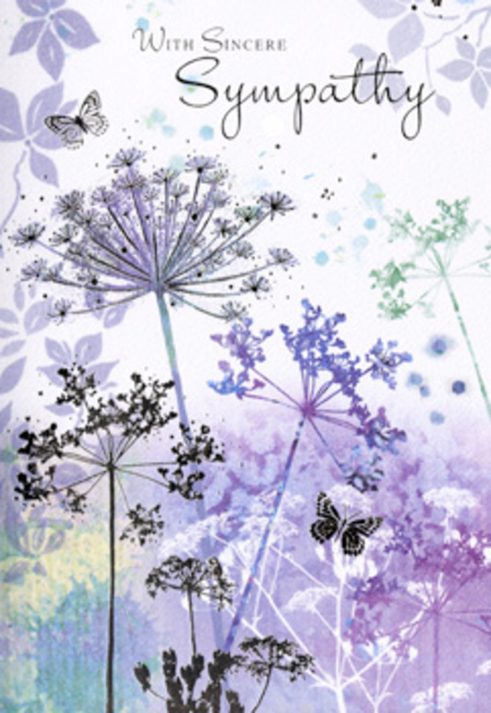 The design inside this sympathy card evokes the quiet, contemplative stillness of an early morning around Friary Park in Friern Barnet, just as the light begins to touch the tops of the trees. A cluster of tall, wild, umbel-like flowers rises from the base of the image, each stem long and fine, bending ever so slightly as though responding to a faint, unseen wind. Their heads are formed of delicate, lace-like florets, painted in soft violets, blue-greys, and hints of cool lavender. The petals are not solid blocks of colour but gentle, transparent washes that overlap, giving the impression of depth without heaviness. Behind them, the background melts into a dreamy blend of muted purple, silvery green, and pale blue, reminiscent of distant fields seen through a light haze. Near the upper portion of the design, a pair of butterflies drifts above the flowers, wings barely defined, tinted with translucent blues and lilacs that seem to glow softly against the more subdued backdrop. Their presence suggests the fragile yet enduring nature of memory, a reminder that love can take on new, quieter forms after loss. The overall layout is spacious and uncluttered, allowing the eye to move slowly from stem to petal to wing, much like one might trace a path along the quiet residential streets that weave through Friern Barnet. As someone who arranges condolence flowers for local families, I sense how this card offers more than a visual; it is an invitation to pause, breathe, and remember, carried on a palette of cool, soothing tones that never overwhelm, only gently comfort.